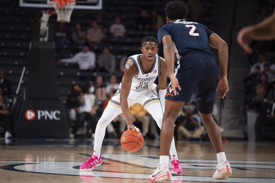 Georgia Tech guard Miles Kelly dribbles as Virginia guard Reece Beekman defends in the second half of an NCAA college basketball game, Saturday, Dec. 31, 2022, in Atlanta. (AP Photo/Hakim Wright Sr.)