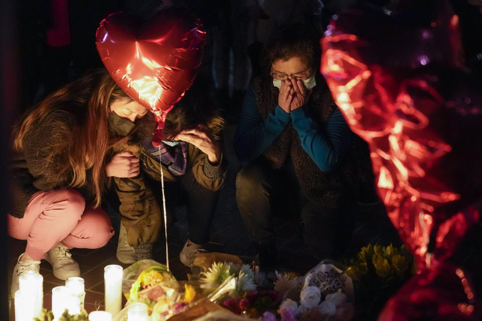 FILE - Mourners pause at a memorial at a vigil honoring the victims of a shooting at the Star Ballroom Dance Studio on Monday, Jan. 23, 2023, in Monterey Park, Calif. A 72-year-old man opened fire on a mostly elderly crowd at a Lunar New Year dance, killing 11 people and wounding nine. The man later died of an apparent self-inflicted gunshot wound. The massacre has been called the deadliest shooting in Los Angeles County history. (AP Photo/Ashley Landis, File)