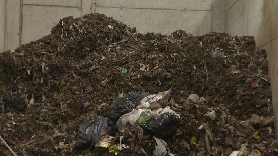 Waste containing contaminants such as glass and plastics are is eventually moved into a landfill.