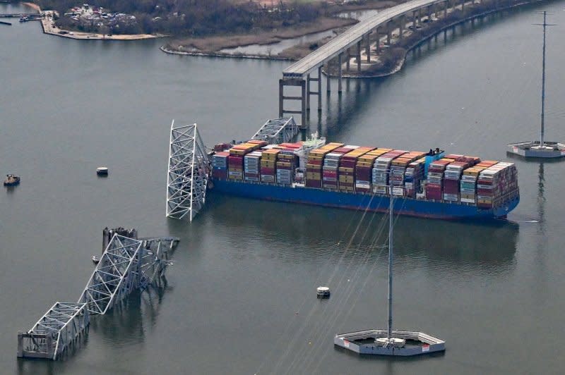 A damaged container ship rests next to a bridge pillar Tuesday in the Patapsco River after crashing into and destroying the Francis Scott Key Bridge at the entrance to Baltimore harbor in Maryland. Photo by David Tulis/UPI