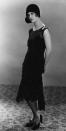 <p>Joan Bennett kept with traditional flapper style—a drop waist and a paneled hem—but the black color makes it timeless. </p>