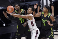 Virginia Tech's Keve Aluma, center, reaches between South Florida's Justin Brown, left, and South Florida's Michael Durr, right, for the ball in the first half of an NCAA college basketball game, Sunday, Nov. 29, 2020, in Uncasville, Conn. (AP Photo/Jessica Hill)