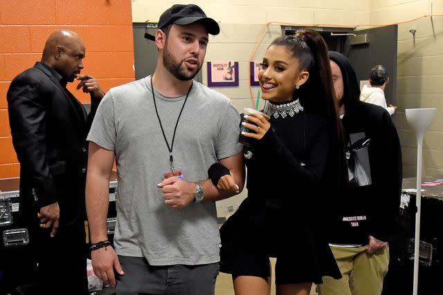 <p>Kevin Mazur/Getty </p> Scooter Braun and Ariana Grande in Phoenix in February 2017