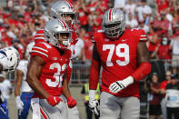 Ohio State running back TreVeyon Henderson, left, celebrates his touchdown against Tulsa with teammate Dawand Jones during the first half of an NCAA college football game Saturday, Sept. 18, 2021, in Columbus, Ohio. (AP Photo/Jay LaPrete)