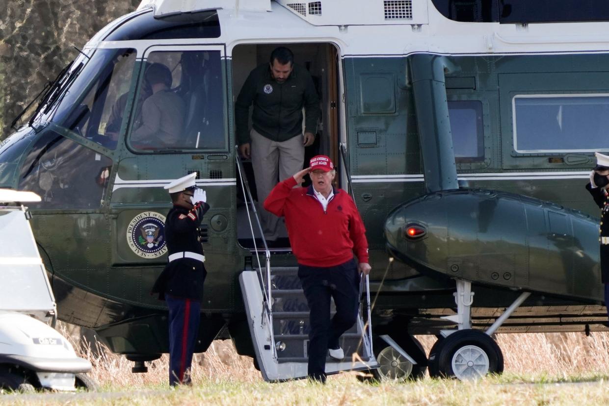 <p>Donald Trump gets off Marine One with son Donald Trump Jr for a round of golf in Sterling, Virginia</p> (REUTERS)