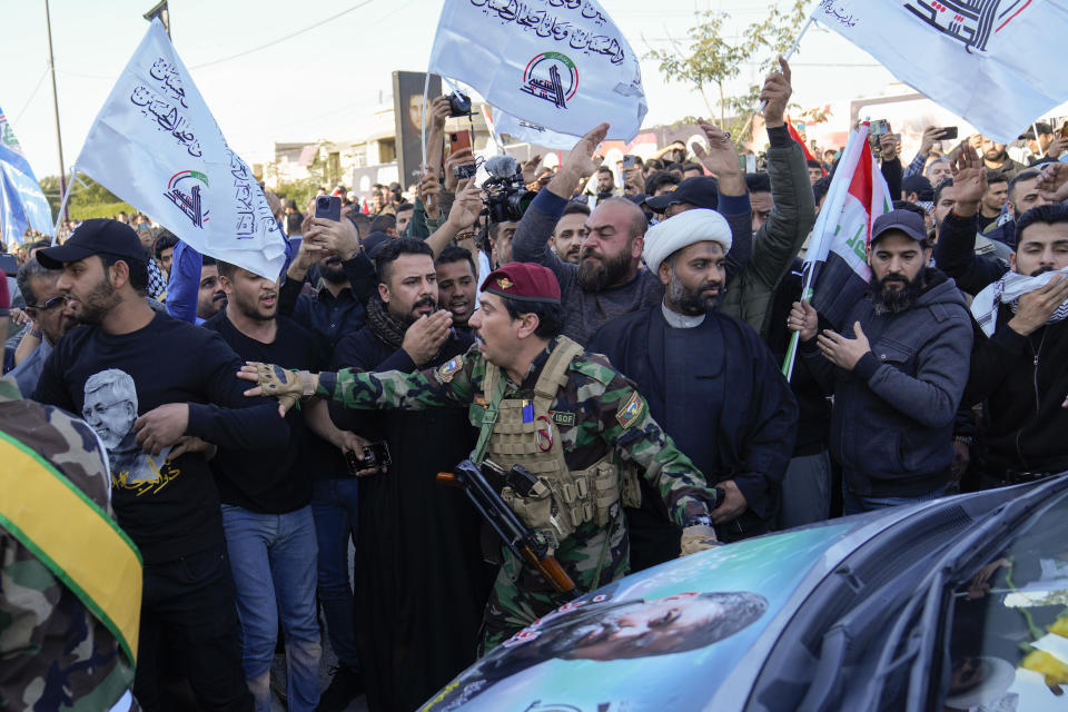 Fighters from the Popular Mobilization Forces, attends the funeral of a commander from the Kataib Hezbollah paramilitary group, Wissam Muhammad Sabir Al-Saadi, known as Abu Baqir Al-Saadi, who was killed in a U.S. airstrike, in Baghdad, Iraq, Thursday, Feb. 8, 2024. The U.S. military says a U.S. drone strike blew up a car in the Iraqi capital Wednesday night, killing the high-ranking commander. (AP Photo/Hadi Mizban)