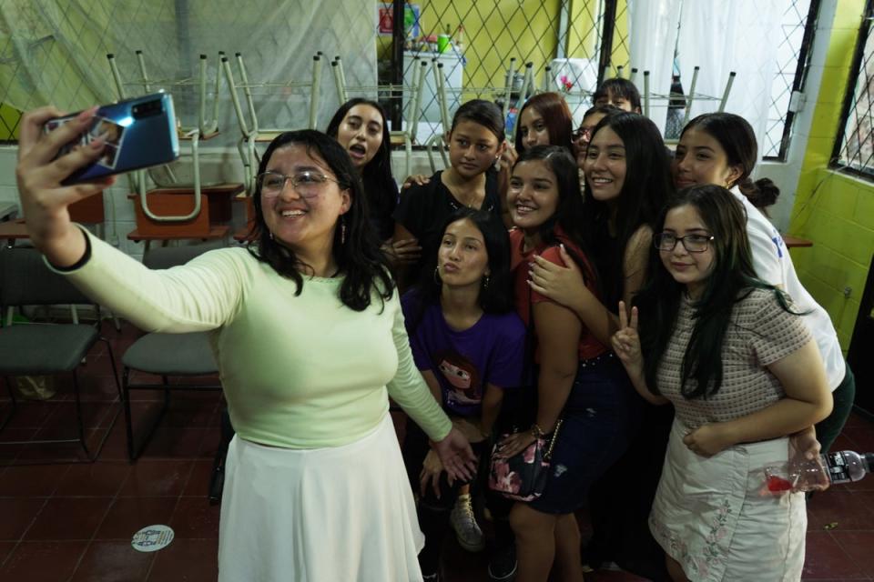 Damaris, 20,  takes a selfie with other girls at  a Red Butterflies session,  in Chalatenango, El Salvador (Victor Peña/Evening Standard)