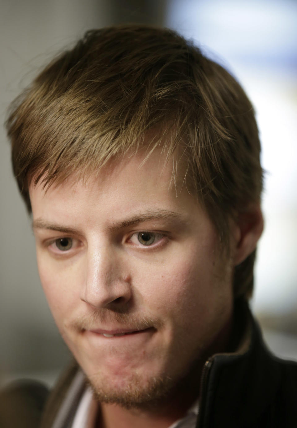 Jordan Houlton, of Toronto, pauses for an interview in Kennedy International Airport en route to a connecting flight to Mexico after the Delta flight from Toronto he was on board skidded off the runway into a snow bank, temporarily suspending all air traffic into and out of the airport, Sunday, Jan. 5, 2014, in New York. Houlton said he slept through the incident. (AP Photo/Kathy Willens)