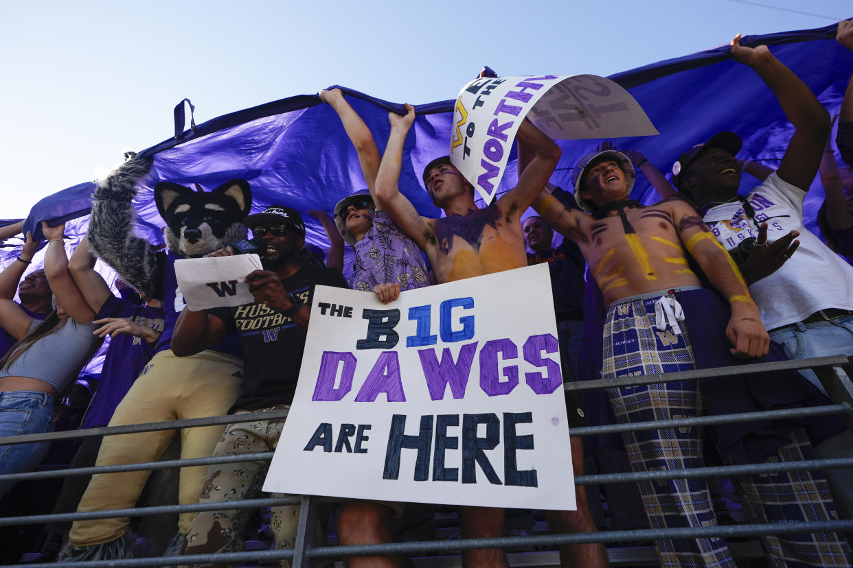 Washington fans celebrate a touchdown by wide receiver Denzel Boston during the first half of an NCAA college football game against Northwestern, Saturday, Sept. 21, 2024, in Seattle. (AP Photo/Lindsey Wasson)