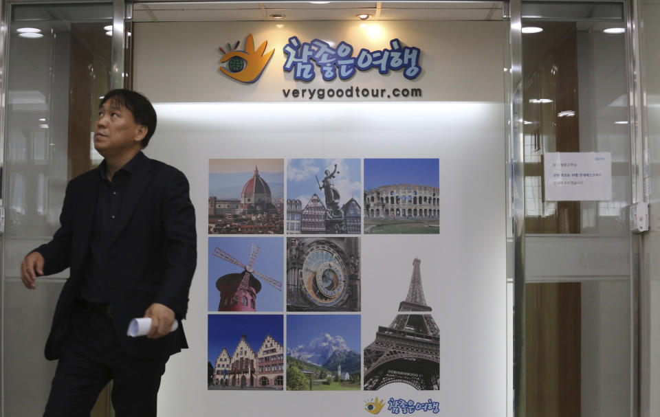 A man stands in front of a gate of the headquarters of Very Good Tour Co. in Seoul, South Korea, Thursday, May 30, 2019. A sightseeing boat carrying 33 South Korean passengers and two crew members collided with another vessel and sank in the Danube River in downtown Budapest. The South Korean tourists are confirmed to have been on a package tour to Hungary sold by the travel agency. (AP Photo/Ahn Young-joon)