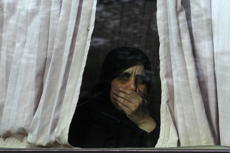 A newly released woman prisoner, who was held by Syrian government, reacts inside a bus upon her arrival at insurgent-held al-Rashideen, Aleppo province