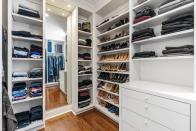 <p>This spacious walk-in closet includes an integrated storage system.</p>