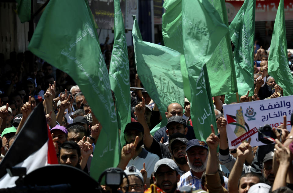 Hamas supporters wave their green and national flags during a protest against Israel's plan to annex parts of the West Bank and U.S. President Donald Trump's mideast initiative, after Friday prayer at the main road of Rafah refugee camp, Gaza Strip, Friday, July 3, 2020. (AP Photo/Adel Hana)