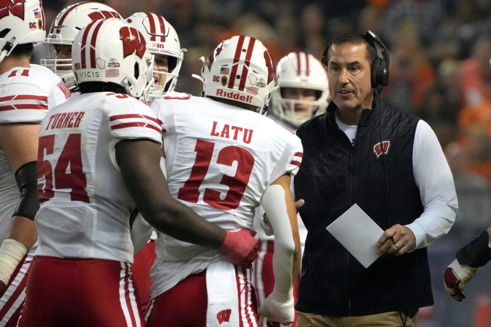 Wisconsin coach Luke Fickell celebrates with players after a touchdown during the first half against Oklahoma State in the Guaranteed Rate Bowl on Dec. 27 in Phoenix.