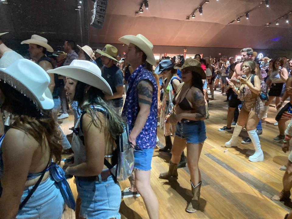 Festivalgoers dance at Diplo's Honky Tonk during the Stagecoach country music festival at Empire Polo Club in Indio, Calif. on Friday, April 28, 2023.