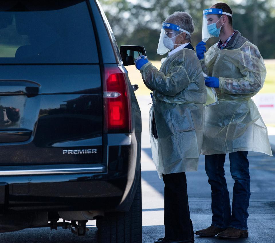 Pam Beumer and James Miracle help as Southeast Alabama Area Health Education Center does free rural drive through COVID-19 testing at Good Hope Baptist Church near Eclectic, Ala., on Monday November 2, 2020.