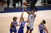 Washington Wizards guard Bradley Beal (3) goes to the basket against Philadelphia 76ers guard George Hill (33), forward Tobias Harris (12) and guard Tyrese Maxey (0) during the first half of Game 4 in a first-round NBA basketball playoff series, Monday, May 31, 2021, in Washington. (AP Photo/Nick Wass)