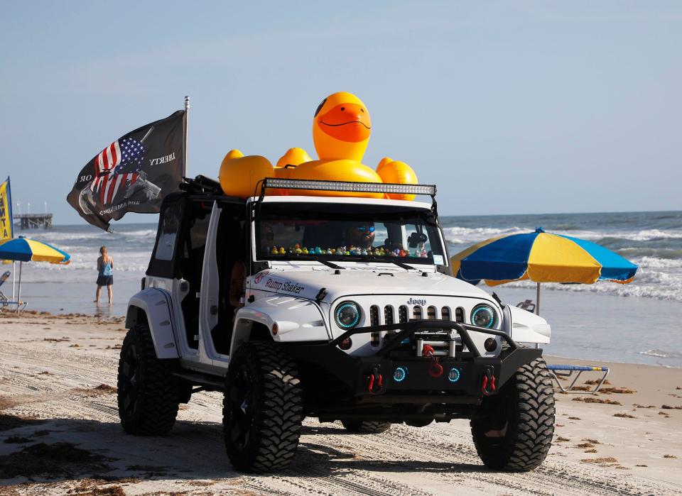 A giant duck rides on the roof of a Jeep during the closing-day "Jeep Beach Sweep" parade at the 2022 edition of Jeep Beach in Daytona Beach.