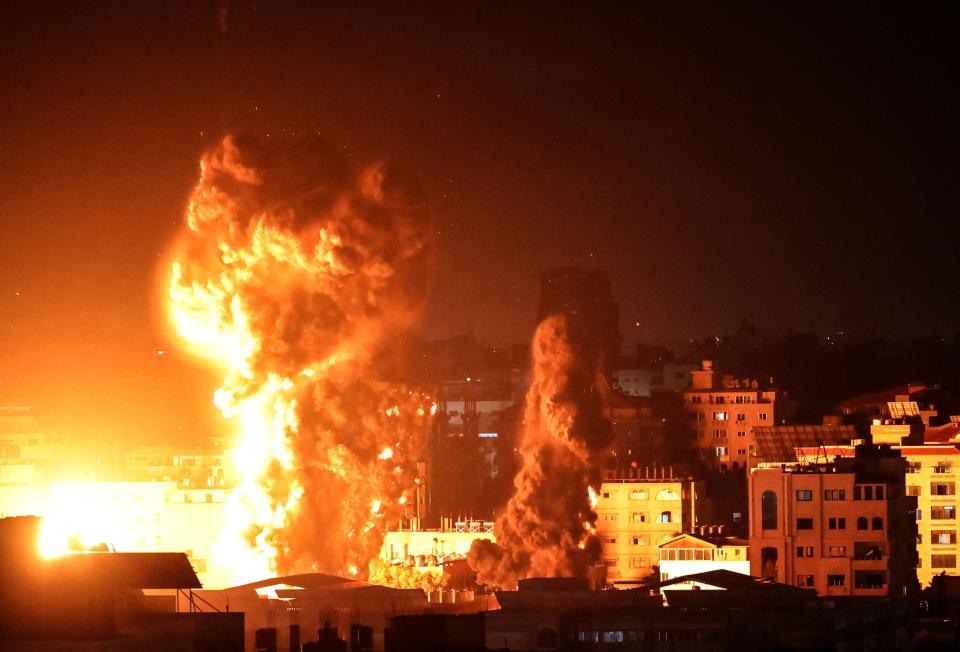 Fire and smoke rise above buildings in Gaza City as Israeli warplanes target the Palestinian enclave early on MondayAFP via Getty Images