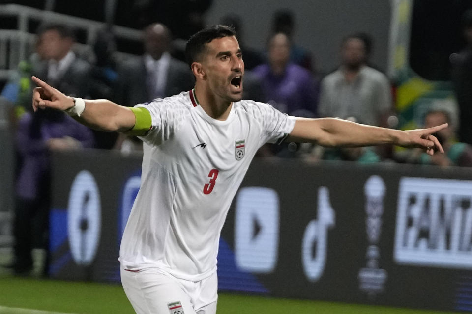 Iran's Ehsan Haji Safi celebrates after scoring in a penalty kick shoot-out during the Asian Cup round of 16 soccer match between Syria and Iran at Abdullah Bin Khalifa Stadium in Doha, Qatar, Wednesday, Jan. 31, 2024. (AP Photo/Thanassis Stavrakis)