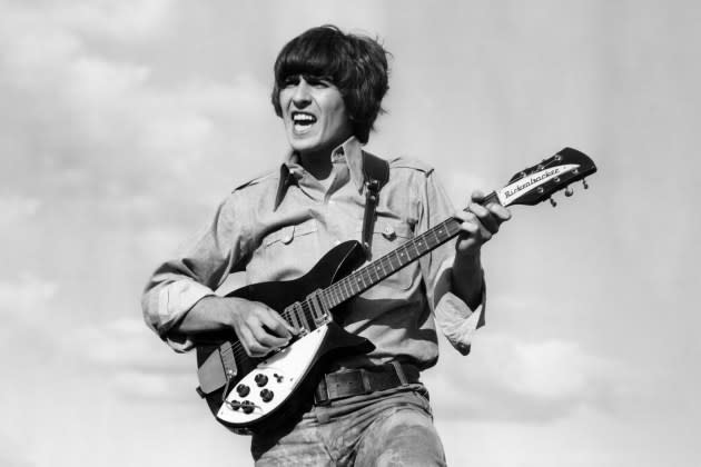 Harrison performs onstage with the Beatles, circa 1966.  - Credit: Michael Ochs Archives/Getty Images