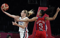 France's Marine Johannes (23), left, drives to the basket past United States' Skylar Diggins (5) during women's basketball preliminary round game at the 2020 Summer Olympics, Monday, Aug. 2, 2021, in Saitama, Japan. (AP Photo/Charlie Neibergall)