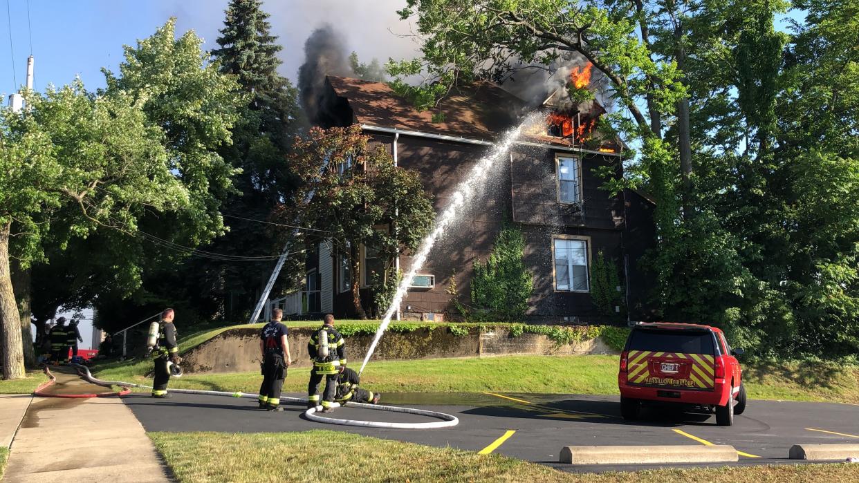 Massillon fire crews battle a blaze Wednesday evening at this house on Second Street NE