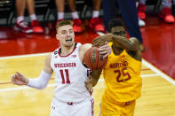 Wisconsin's Micah Potter (11) and Maryland's Jalen Smith (25) go after a rebound during the first half of an NCAA college basketball game Tuesday, Jan. 14, 2020, in Madison, Wis. (AP Photo/Andy Manis)