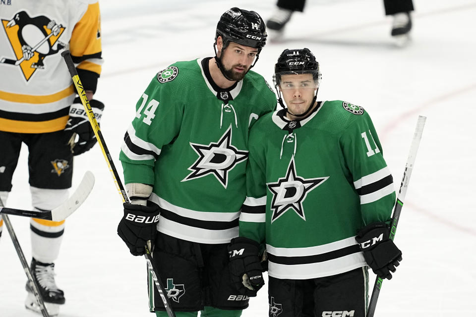 FILE - Dallas Stars left wing Jamie Benn (14) and center Logan Stankoven (11) talk before a face off in the third period of an NHL hockey game against the Pittsburgh Penguins in Dallas, March 22, 2024. There is quite an age gap for the Western Conference champion Dallas Stars. (AP Photo/Tony Gutierrez, File)