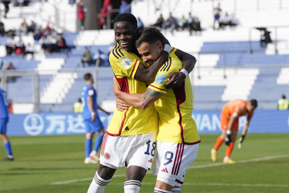 Colombia's Tomas Angel, right, is congratulated after scoring his side's 3rd goal against Slovakia during a FIFA U-20 World Cup round of 16 soccer match at the Bicentenario stadium in San Juan, Argentina, Wednesday, May 31, 2023. (AP Photo/Ricardo Mazalan)