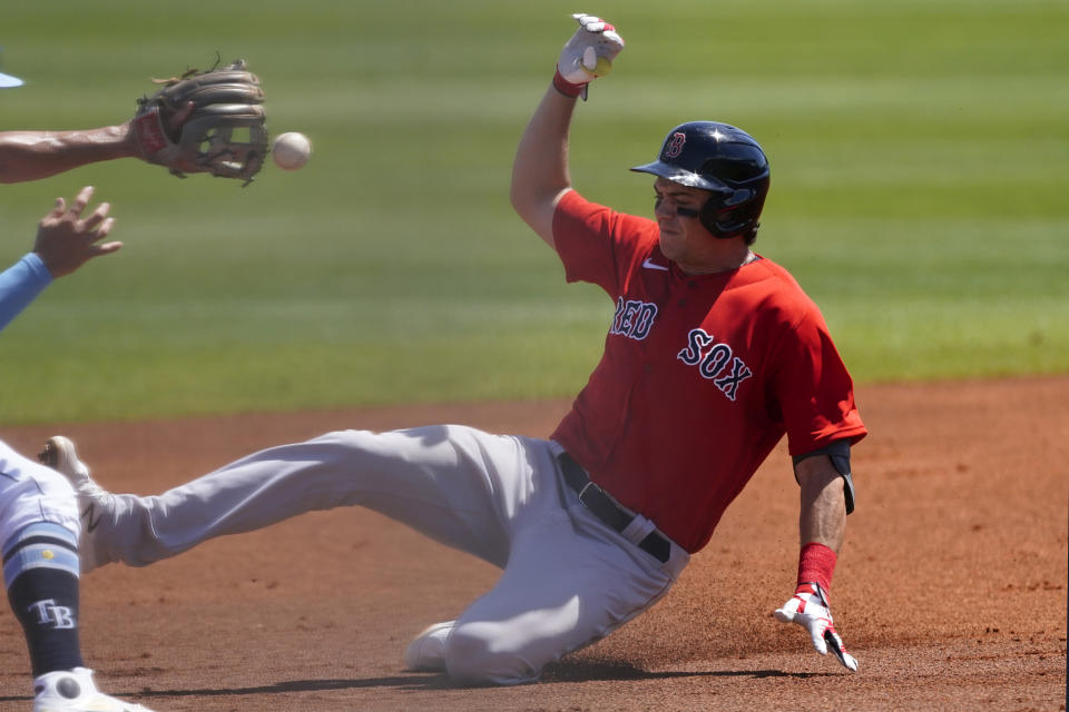 Boston Red Sox' Bobby Dalbec slides into second base with a double in the second Inning of a spring training baseball game against the Tampa Bay Rays on Monday, March 15, 2021, in Port St. Lucie, Fla.. (AP Photo/John Bazemore)