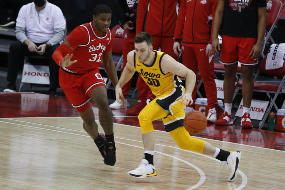 Iowa's Connor McCaffery, right, drives to the basket as Ohio State's E.J. Liddell defends during the first half of an NCAA college basketball game Sunday, Feb. 28, 2021, in Columbus, Ohio. (AP Photo/Jay LaPrete)