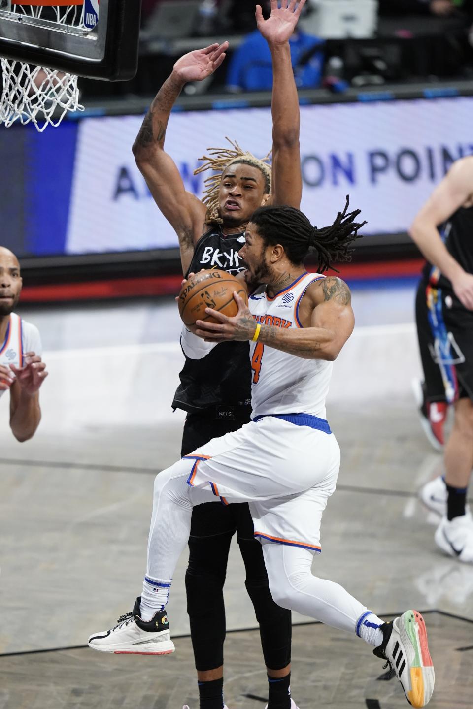 New York Knicks' Derrick Rose (4) drives past Brooklyn Nets' Nicolas Claxton (33) during the second half of an NBA basketball game Monday, April 5, 2021, in New York. (AP Photo/Frank Franklin II)