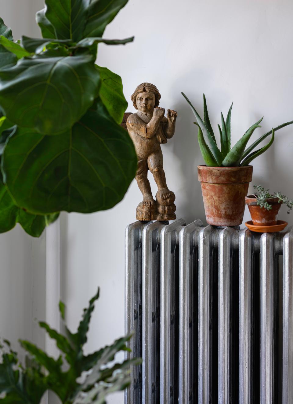 This plant-filled corner is reminiscent of a sculpture garden thanks to an angel found during travels in Europe.