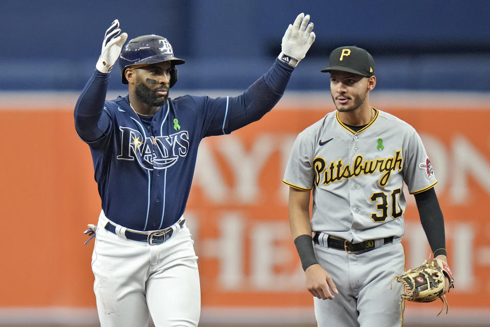 Tampa Bay Rays' Yandy Diaz celebrates his double off Pittsburgh Pirates starting pitcher Vince Velasquez in front of shortstop Tucupita Marcano (30) during the first inning of a baseball game Thursday, May 4, 2023, in St. Petersburg, Fla. (AP Photo/Chris O'Meara)