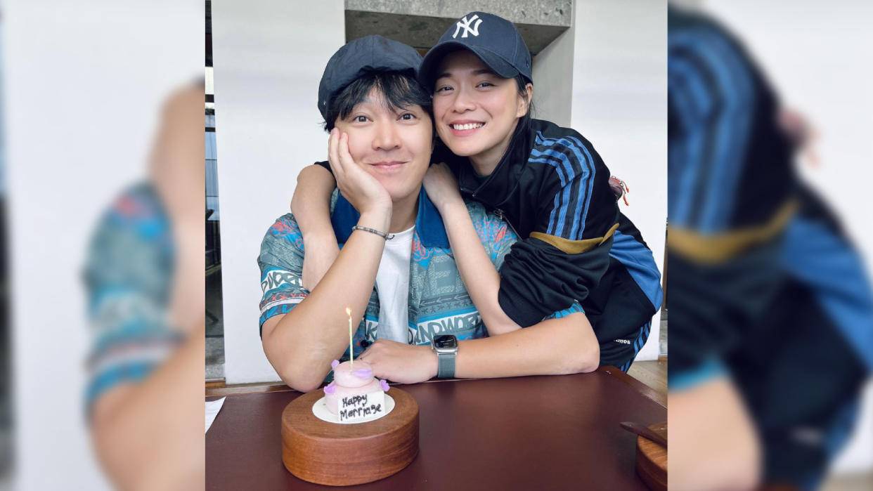 Jeffrey Xu and Felicia Chin with a birthday cake behind a table