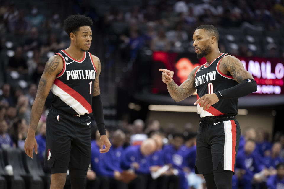 Portland Trail Blazers guard Damian Lillard explains defensive coverage with teammate Anfernee Simons in a preseason game on Oct. 9, 2022. (AP Photo/José Luis Villegas)