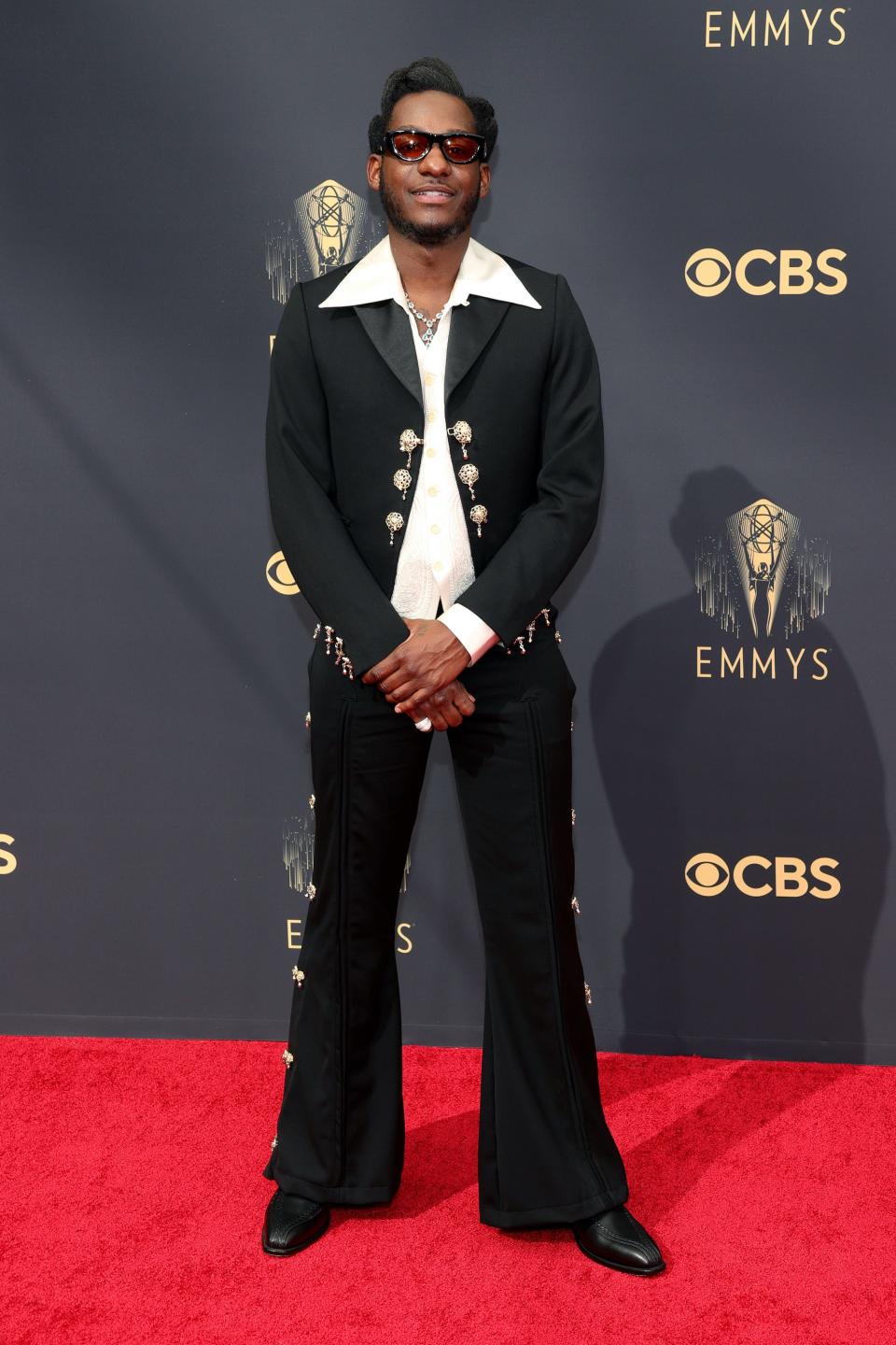 Leon Bridges wears a black suit on the Emmys red carpet.