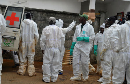 Emergency workers are pictured at the central morgue at Connaught hospital in Freetown, Sierra Leone August 15, 2017 REUTERS/Ernest Henry