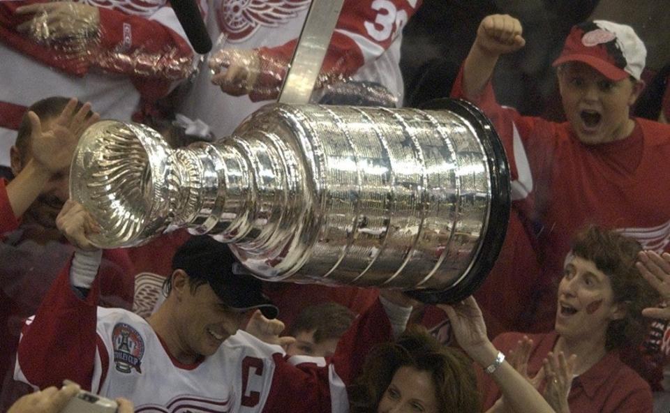 Steve Yzerman, holds up the Stanley Cup for Detroit Red Wings fans after winning Game 5, 3-1, at Joe Louis Arena, June 13, 2002 in Detroit.