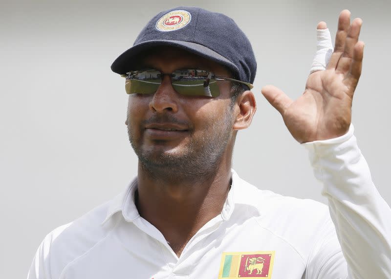 Sri Lanka's Sangakkara waves at his fans during the fourth day of their second test cricket match against India in Colombo