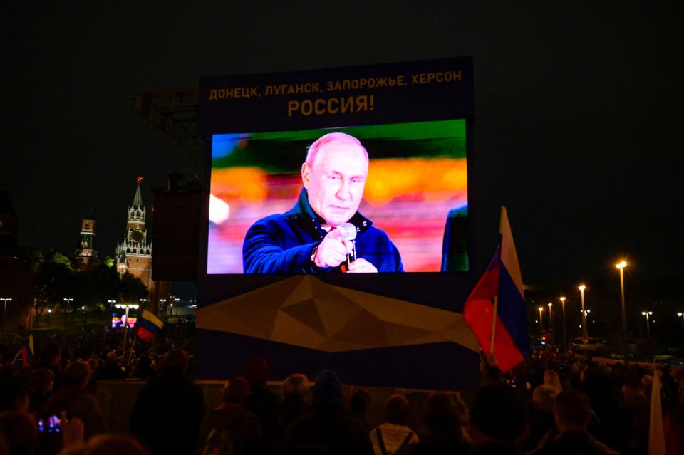 Russian President Vladimir Putin is seen on a screen as he addresses a rally and a concert marking the annexation of four regions of Ukraine Russian troops occupy - Lugansk, Donetsk, Kherson and Zaporizhzhia, in central Moscow on September 30, 2022.