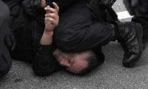 <p>Police detain a protestor as they separate leftist and nationalist demonstrators in Chemnitz, eastern Germany, Saturday, Sept. 1, 2018, after several nationalist groups called for marches protesting the killing of a German man last week, allegedly by migrants from Syria and Iraq. (Photo: Jens Meyer/AP) </p>