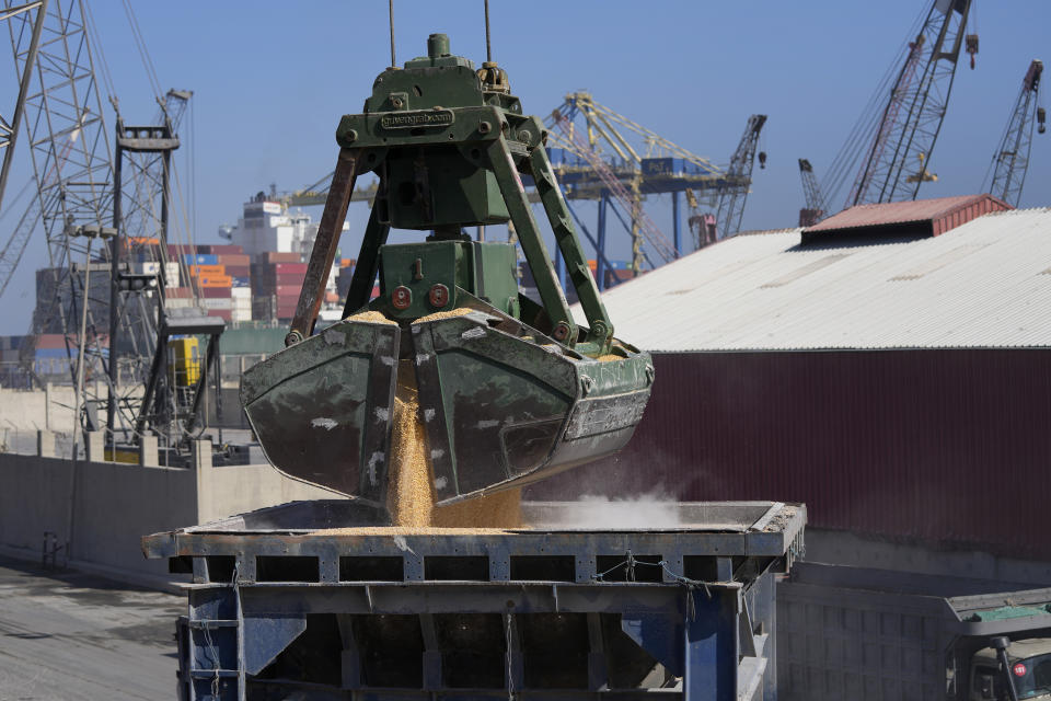 Trucks being filled with Ukrainian corn from the ship AK Ambition, sailing under the flag of Panama at Tripoli seaport, in Tripoli, north Lebanon, Monday, Sept. 26, 2022. A ship carrying thousands of tons of corn and vegetable oil arrived in northern Lebanon Monday from war-ravaged Ukraine, the first of its kind since Russia's invasion of its neighbor began seven months ago. (AP Photo/Hassan Ammar)