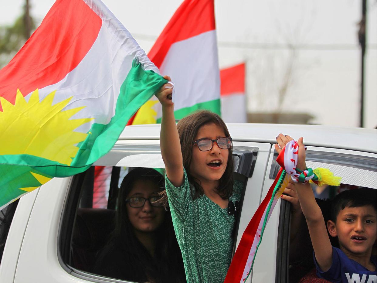 Iraqi children wave Kurdish flags in Kirkuk, but the vote has angered Baghdad and neighbours Turkey and Iran, where many Kurds live: AFP/Getty