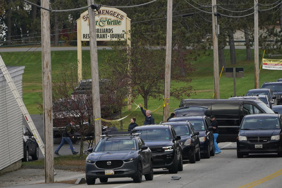 FILE - A body is wheeled out on a stretcher at Schemengees Bar and Grille, Oct. 26, 2023, in Lewiston, Maine. Army officials testified, Thursday, March 7, 2024, before a special commission investigating the deadliest mass shooting in Maine history, which was committed by a former reservist. (AP Photo/Robert F. Bukaty, File)