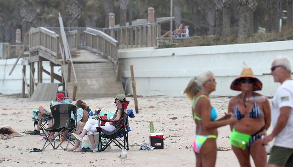 Beachgoers hang out on Monday at Andy Romano Beachfront Park in Ormond Beach, where damage from Tropical Storm Ian is still visible as yet another storm heads toward Volusia and Flagler counties this week. Subtropical Storm Nicole is expected to approach Central Florida on Wednesday, but it's initial effects were already evident on Monday.