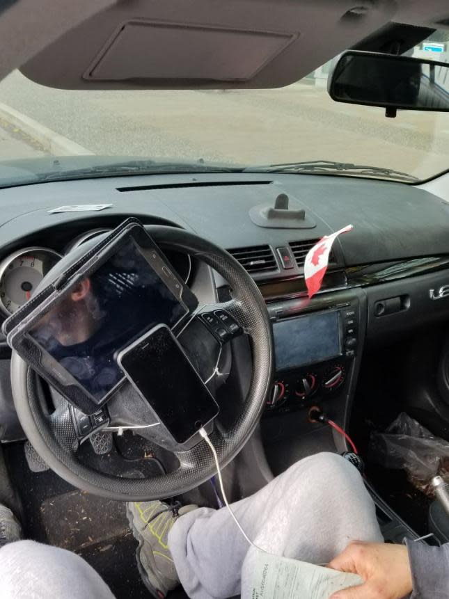 Traffic police fined a driver in Vancouver after he was found to have his phone and tablet strapped to his steering wheel: Vancouver Police / Twitter