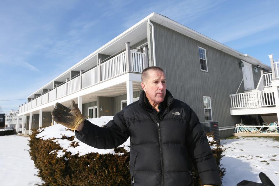 Ken Mason, the innkeeper of the Seaside Inn in Kennebunkport, shows how high the ocean water reached when it demolished the seawall and the dunes in front of his property.