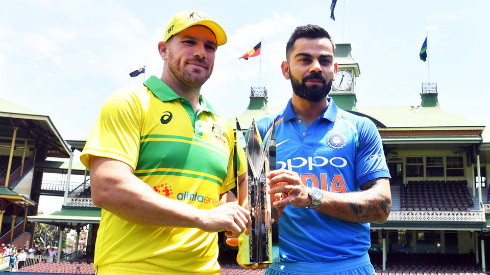 Aaron Finch (pictured left) holding the trophy with with Virat Kohli (pictured right) at the SCG.